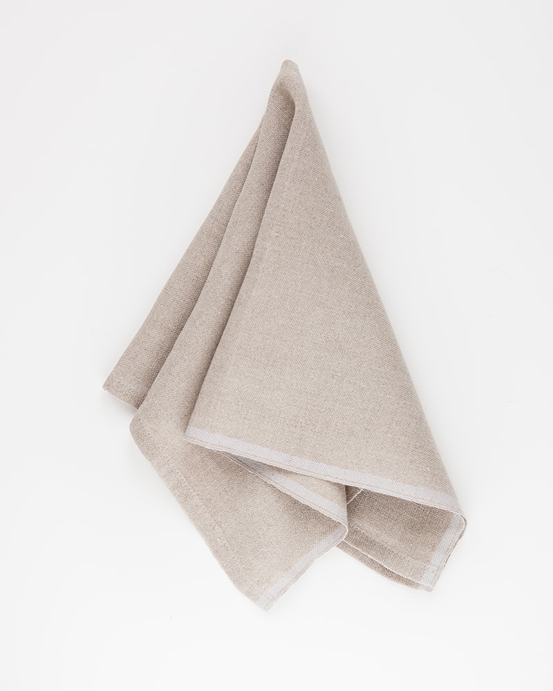 Mungo Natural Flax selvedge napkin with a silver stripe that runs down the true selvedge, woven of our antique looms in plettenberg bay