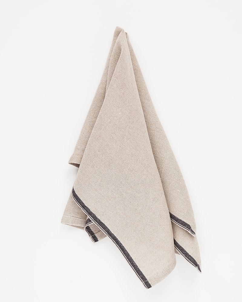 Mungo Natural Flax selvedge napkin with a french navy stripe that runs down the true selvedge, woven of our antique looms in plettenberg bay