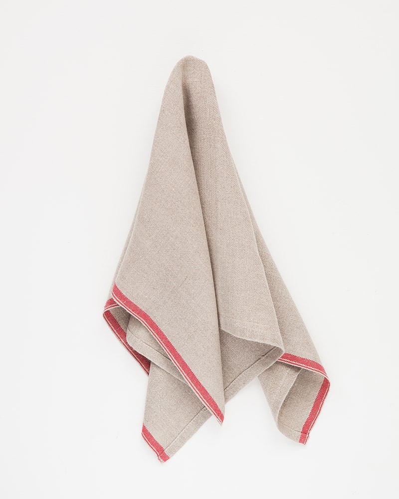 Mungo Natural Flax selvedge napkin with a red stripe that runs down the true selvedge, woven of our antique looms in plettenberg bay