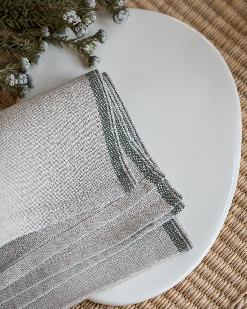Flax Selvedge Napkins with a Urban Olive stripe that runs along the true selvedge, woven at the Mungo Mill on antique Ruti looms