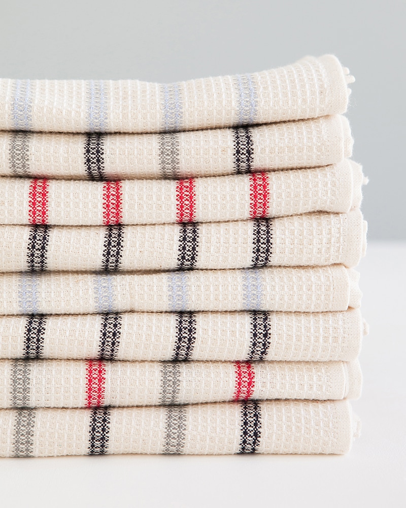 Mungo Linen and Cotton Waffle Weave Kitchen Towels in Lavender, Red, Black and Grey Stripe, folded and stacked. Made with all natural fibres on the looms at our mill in Plettenberg Bay.