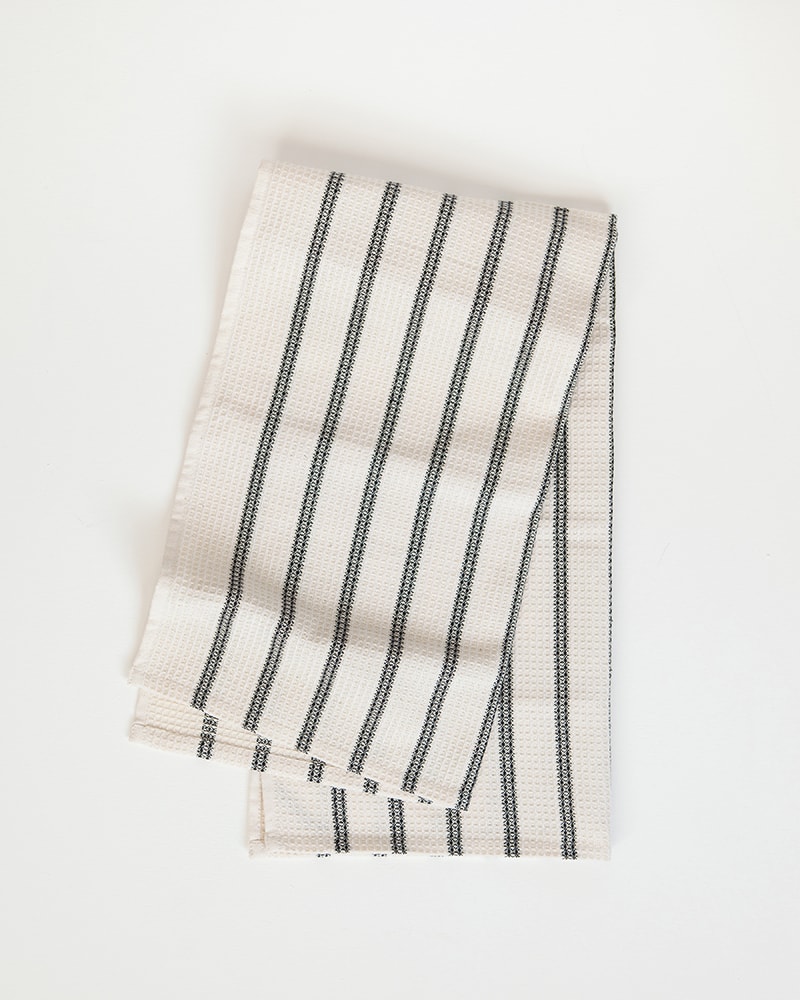 Mungo Linen and Cotton Waffle Weave Kitchen Towel in Black Stripe, folded. Made with all natural fibres on the looms at our mill in Plettenberg Bay.