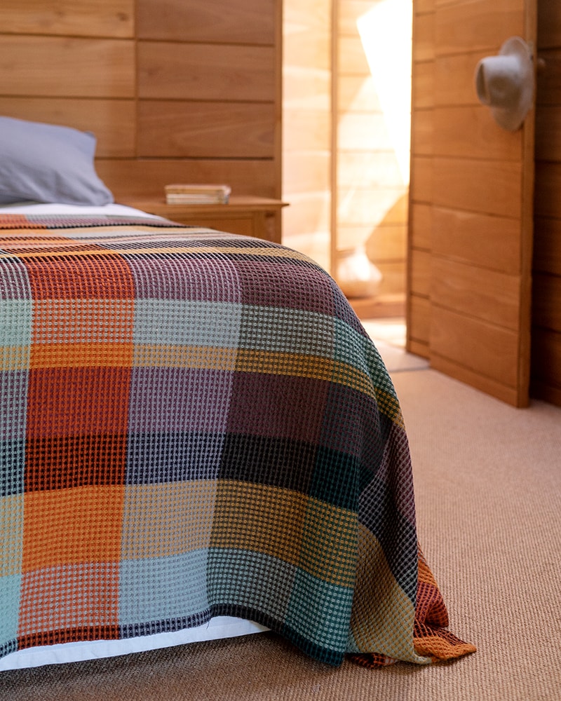 Mungo Vrou Vrou blanket in Cypress colourway, shot at the Cape Point. Homeware textiles woven at the Mungo Mill in South Africa