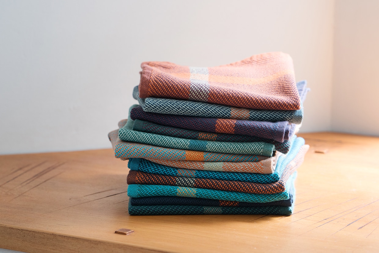 Mungo Wash Cloth stack. Reusable cotton hand towels / face cloths, woven in colourful striped designs at the Mungo Mill. Shipping worldwide.