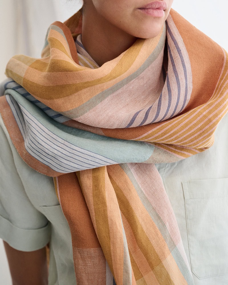 Close up of model wearing the 100% Linen scarf in Jewel.