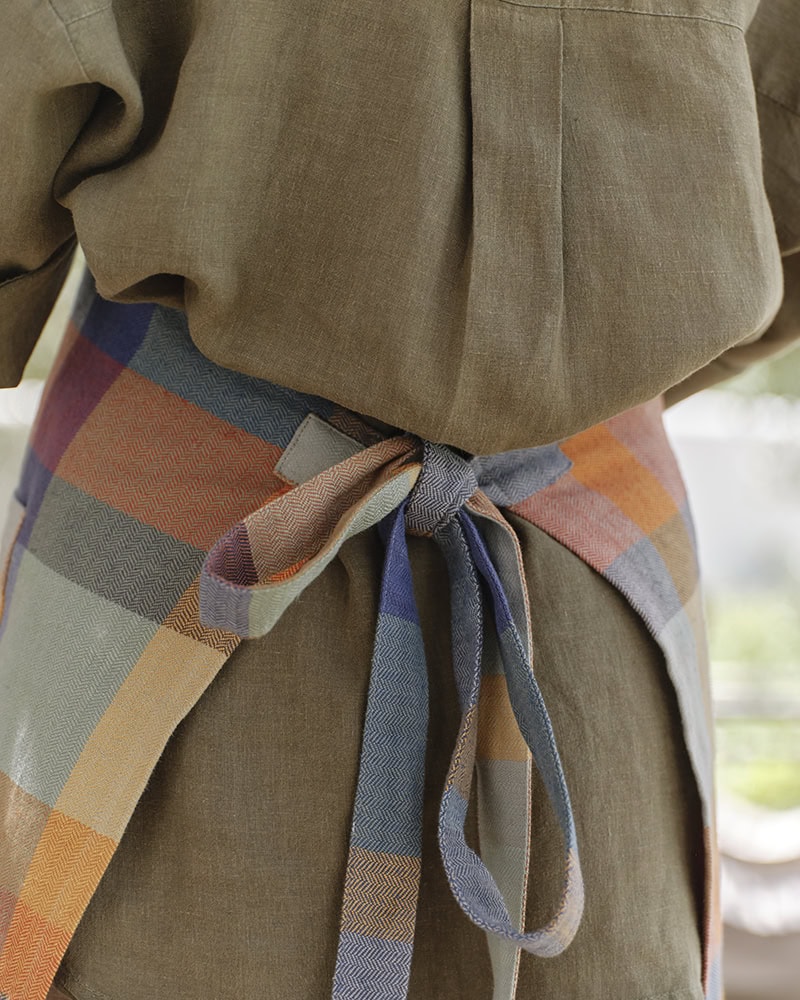Alles Apron in Paloma tied at the back.