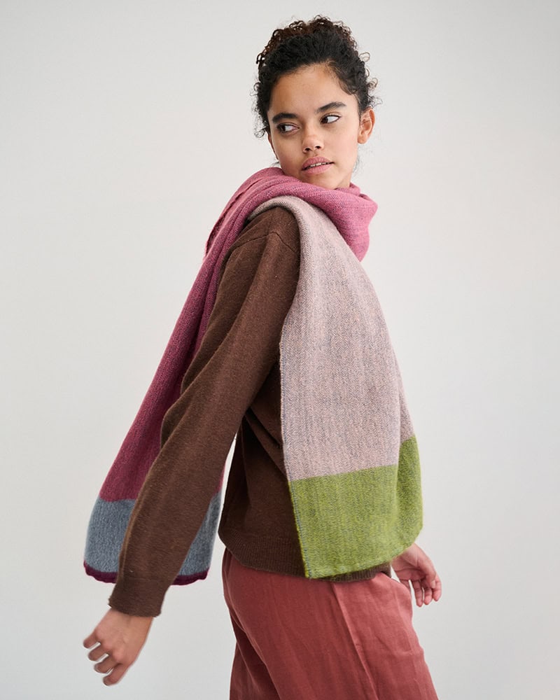 Model walking and looking back wearing Mos Wrap in Firefly.
